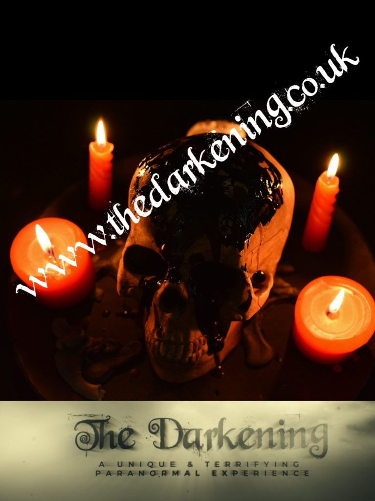 A promotional poster for "The Darkening" event at Merley House. The poster features an image with three lit candles and a skull in the centre. Text in the middle of the image reads www.thedarkening.co.uk"