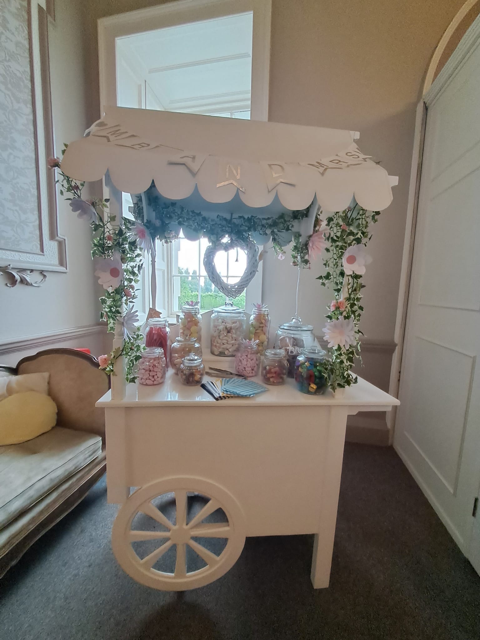 A retro themed sweet cart with jars of sweets